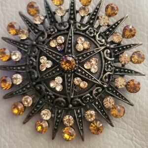 Circular Broach Starburst design Yellow and Clear stones 2 inches diameter
